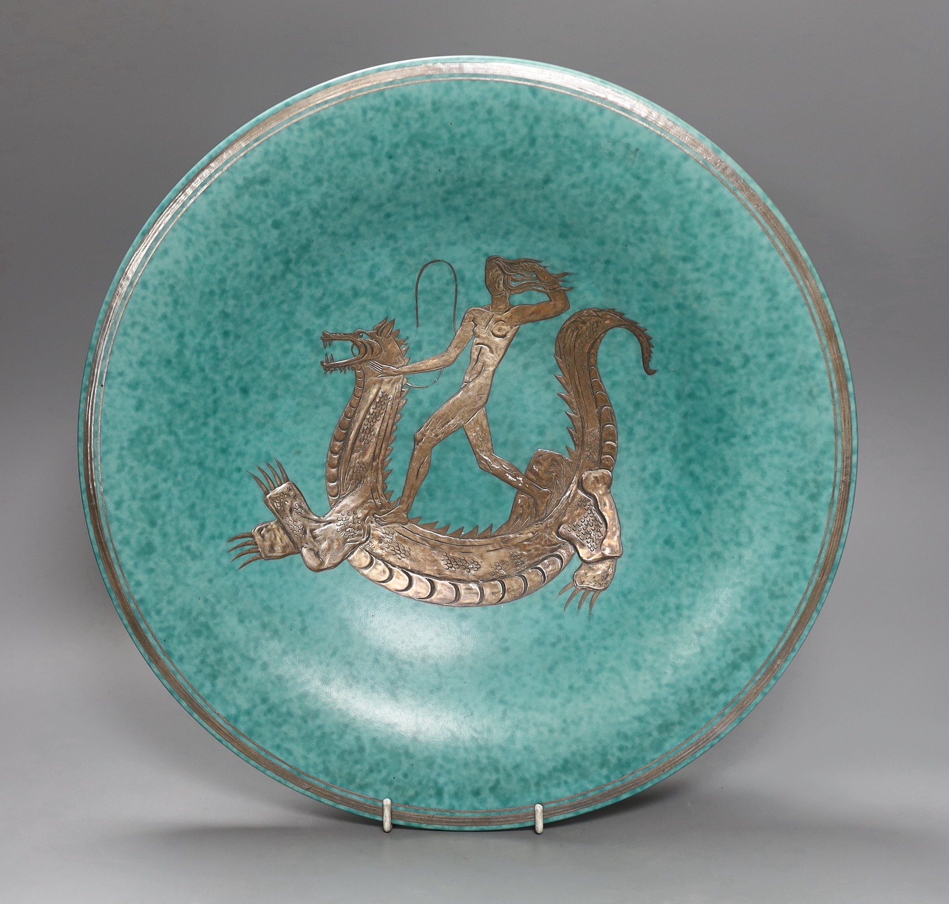 A Gustavsberg Wilhelm Kåge design Argenta bowl decorated with a figure riding a dragon, no. 1035, 38cm diameter